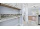 Butler's pantry with granite counters, cabinets, and access to the living area and bathroom at 3550 Pampas Dr. # 2, Myrtle Beach, SC 29577