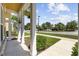 Covered porch with hanging plants and decorative columns overlooking the manicured lawn at 3550 Pampas Dr. # 2, Myrtle Beach, SC 29577