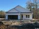 A charming home featuring an attached two-car garage and a welcoming front entrance, set against a natural backdrop at 3597 Valley Forge Rd., Aynor, SC 29511