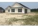A new construction home with white siding and black shutters also features an attached garage at 3601 Valley Forge Rd., Aynor, SC 29511