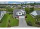 Aerial view of a charming two-story home with brick and vinyl siding, a well-kept lawn, and a nearby pond at 417 Pennington Loop, Myrtle Beach, SC 29588