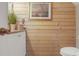 Rustic bathroom with wooden walls, white vanity, and modern fixtures at 417 Pennington Loop, Myrtle Beach, SC 29588