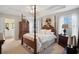 An elegant bedroom features a four-poster bed, tray ceilings, and abundant natural light at 417 Pennington Loop, Myrtle Beach, SC 29588