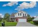 Inviting two-story home with a brick and siding exterior, well-kept lawn, and a double-car garage at 417 Pennington Loop, Myrtle Beach, SC 29588