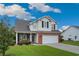 Charming two-story home with a brick and siding facade, attached garage, and well-manicured lawn at 417 Pennington Loop, Myrtle Beach, SC 29588