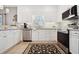 Modern kitchen with white cabinetry, stainless steel appliances, tile floors, and granite countertops at 417 Pennington Loop, Myrtle Beach, SC 29588