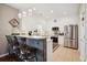Bright kitchen featuring white cabinets, stainless steel appliances, granite countertops, and bar seating at 417 Pennington Loop, Myrtle Beach, SC 29588