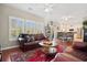 Bright and open living room with large windows, hardwood floors, and a comfortable seating area at 417 Pennington Loop, Myrtle Beach, SC 29588