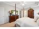 Spacious main bedroom features a four-poster bed, ceiling fan, and an ensuite bathroom at 417 Pennington Loop, Myrtle Beach, SC 29588
