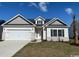 Charming single-Gathering home featuring a two-car garage, landscaped yard, and classic architectural details at 418 Lifestyle Court, Surfside Beach, SC 29575