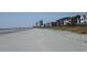 Scenic beach view featuring the coastline, sandy shore, and distant buildings against a clear sky at 422 Lifestyle Court, Surfside Beach, SC 29575