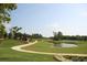 Serene golf course view with a pond, lush green grass, and a charming shelter in a tranquil setting at 422 Lifestyle Court, Surfside Beach, SC 29575