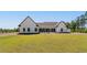 Expansive backyard showcasing a modern farmhouse, lush lawn, and a black fence offering privacy and a sense of openness at 4426 Still Pond Rd., Conway, SC 29526