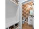 Stylish powder room featuring patterned wallpaper, modern vanity, and wood-look flooring, adding a touch of elegance to the home at 4426 Still Pond Rd., Conway, SC 29526
