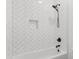 Modern tiled shower and tub with a black shower head, black water knobs, and a built-in niche at 4426 Still Pond Rd., Conway, SC 29526