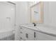 Elegant bathroom featuring a wooden framed mirror, quartz countertop, and a tiled shower at 4426 Still Pond Rd., Conway, SC 29526