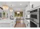 Bright kitchen showcasing stainless steel appliances, island, and eat-in breakfast area at 4426 Still Pond Rd., Conway, SC 29526