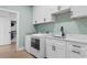 Well-equipped laundry room with a sink, modern appliances, and plenty of cabinet storage at 4426 Still Pond Rd., Conway, SC 29526