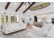 Bright, open-concept living room with wooden beams, white sofas, and a view into a modern kitchen at 4426 Still Pond Rd., Conway, SC 29526