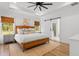 A serene main bedroom with hardwood floors, natural light, and a barn door leading to the bathroom at 4426 Still Pond Rd., Conway, SC 29526