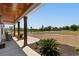 Inviting front porch with wood columns, offering a relaxing outdoor space with scenic views of the expansive front yard at 4426 Still Pond Rd., Conway, SC 29526