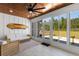 Bright sunroom with wood ceiling, a surfboard decoration, comfortable seating, and large windows offering natural light at 4426 Still Pond Rd., Conway, SC 29526