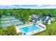 Aerial view of a community pool, tennis courts and clubhouse surrounded by trees at 455 Dornoch Dr., Pawleys Island, SC 29585