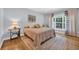 Inviting bedroom featuring a large window, natural light, and hardwood floors at 455 Dornoch Dr., Pawleys Island, SC 29585