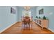 Light-filled dining room featuring hardwood floors, stylish chandelier, and a large window at 455 Dornoch Dr., Pawleys Island, SC 29585