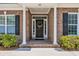 Inviting front entrance with a brick porch and decorative wreath on a black door at 455 Dornoch Dr., Pawleys Island, SC 29585