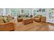 Bright living room with wicker furniture, hardwood floors and multiple windows at 455 Dornoch Dr., Pawleys Island, SC 29585
