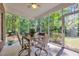 Relaxing screened porch with wood table and chairs, perfect for enjoying the backyard view at 455 Dornoch Dr., Pawleys Island, SC 29585