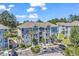 Beautiful condo with stone accents, white balconies, well-maintained landscaping and plenty of parking spaces at 4773 Wild Iris Dr. # 301, Myrtle Beach, SC 29577