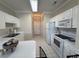 A well-lit kitchen featuring white cabinets, appliances, and tile flooring at 4773 Wild Iris Dr. # 301, Myrtle Beach, SC 29577