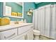Clean bathroom with blue walls, white vanity, and decorative wall art at 512 Chanted Dr., Murrells Inlet, SC 29576