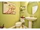 Cozy powder room with floral artwork, unique mirror and pedestal sink at 512 Chanted Dr., Murrells Inlet, SC 29576
