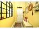 Welcoming entryway with yellow walls, decor, a wooden bench, and an ornate mirror, creating a warm first impression at 512 Chanted Dr., Murrells Inlet, SC 29576