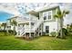Stunning two-story home with a spacious deck, outdoor seating, and beautifully landscaped yard at 512 Chanted Dr., Murrells Inlet, SC 29576