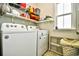 Functional laundry room with washer, dryer, and storage shelves at 512 Chanted Dr., Murrells Inlet, SC 29576