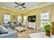 Bright living room with yellow walls, recessed ceiling, and comfortable furnishings, offering an inviting gathering space at 512 Chanted Dr., Murrells Inlet, SC 29576