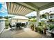 Relaxing outdoor patio with dining set, awning, and green plants at 512 Chanted Dr., Murrells Inlet, SC 29576