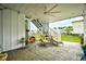 Covered patio with stylish seating, a ceiling fan, and a view of the landscaped backyard and neighboring homes at 512 Chanted Dr., Murrells Inlet, SC 29576
