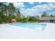 Sparkling community pool featuring a playground, picnic tables, and mature trees for a relaxing atmosphere at 512 Chanted Dr., Murrells Inlet, SC 29576