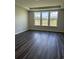 Bedroom features hardwood floors, neutral paint, a tray ceiling and views of the backyard at 543 Oak Landing Dr., Myrtle Beach, SC 29588