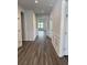 Hallway with hardwood floors, white wainscoting, neutral paint and open doorway to the living room at 543 Oak Landing Dr., Myrtle Beach, SC 29588