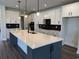 Open concept kitchen features an island, white cabinets, black hardware, stainless steel appliances and modern pendant lighting at 543 Oak Landing Dr., Myrtle Beach, SC 29588