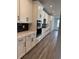 Bright kitchen with black hardware, stainless steel appliances, modern backsplash and white cabinets at 543 Oak Landing Dr., Myrtle Beach, SC 29588