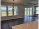 Open living space with hardwood flooring, multiple windows with views of backyard, and access to the patio at 543 Oak Landing Dr., Myrtle Beach, SC 29588