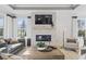 Bright living room features a fireplace, large windows, and stylish furniture at 543 Oak Landing Dr., Myrtle Beach, SC 29588