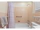 Bathroom featuring pink tile, shower with curtain, grab bar, and updated fixtures at 558 Juniper Dr., Myrtle Beach, SC 29577